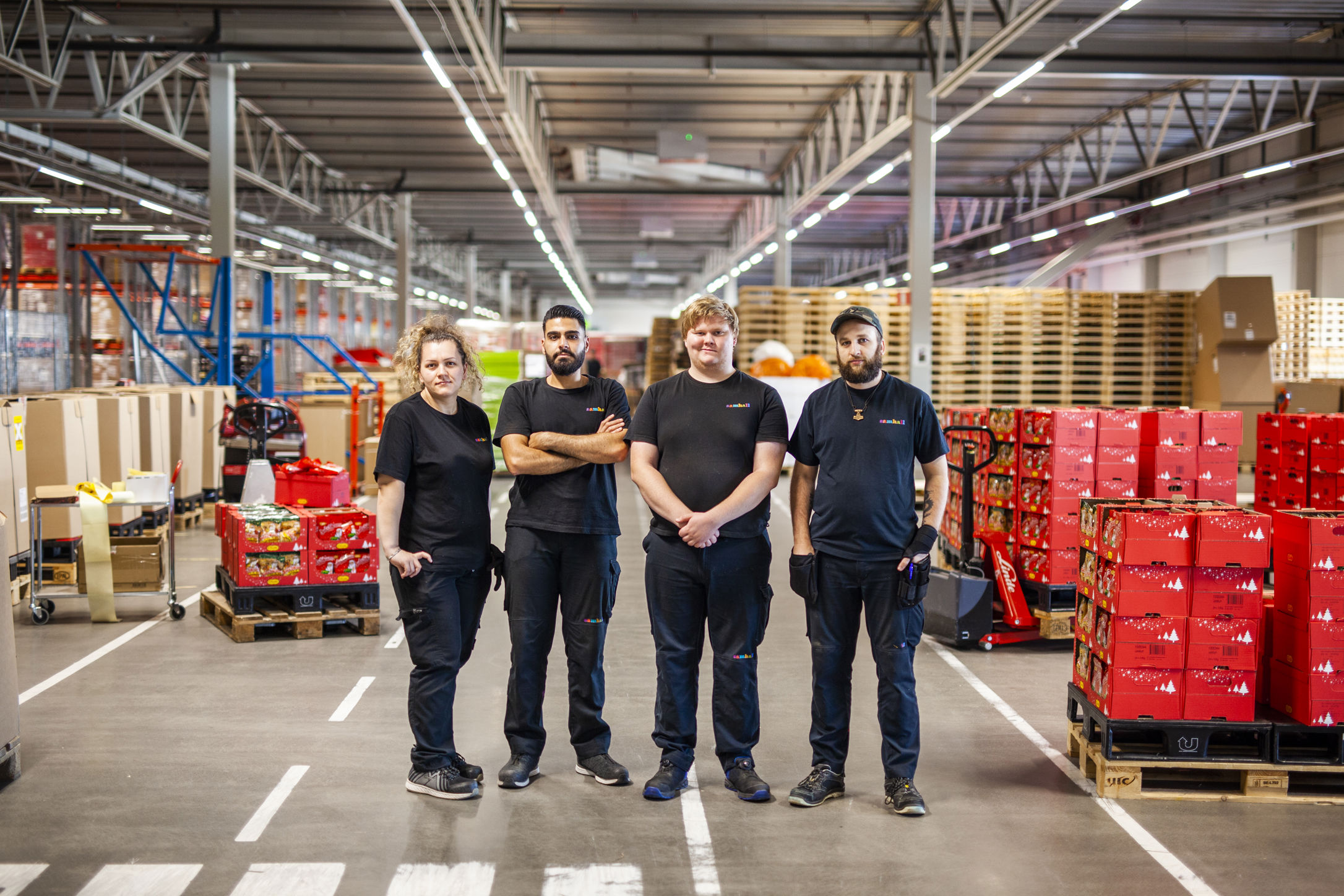 En grupp Samhallanställda står i en lagerlokal.